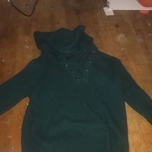 this is a green sweater with a hood on the back